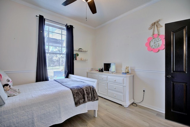 bedroom featuring light wood finished floors, baseboards, a ceiling fan, and crown molding