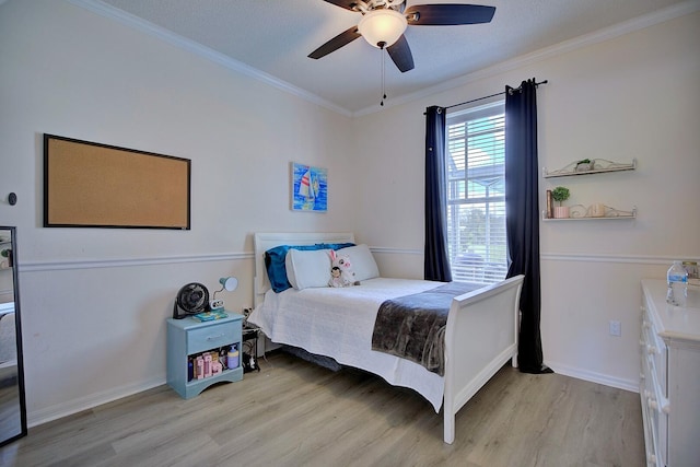 bedroom with ceiling fan, ornamental molding, light wood-style flooring, and baseboards