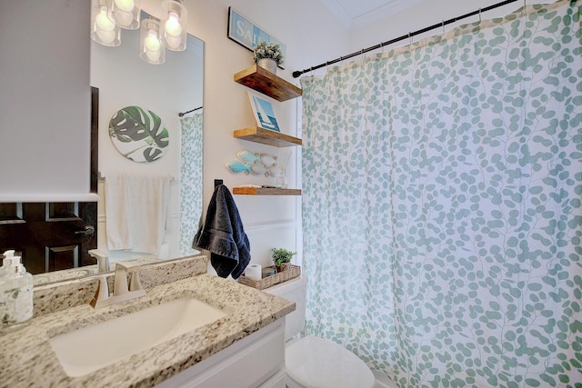 bathroom featuring ornamental molding, vanity, and toilet