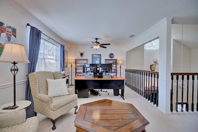 home office with ornamental molding, visible vents, a textured ceiling, and carpet flooring