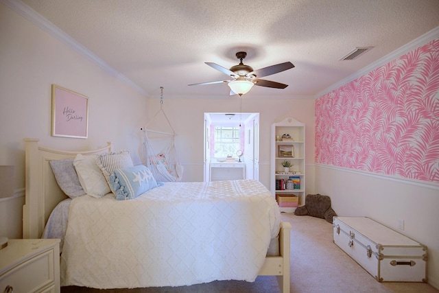 bedroom featuring a textured ceiling, ornamental molding, carpet flooring, and visible vents