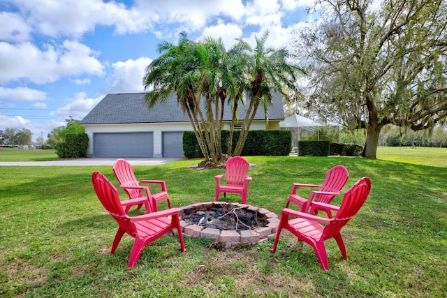 view of yard with an outdoor fire pit and an attached garage