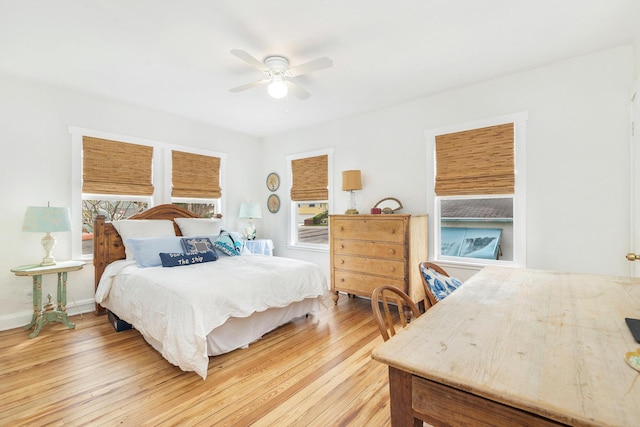 bedroom featuring ceiling fan, wood finished floors, and baseboards