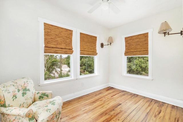 unfurnished room featuring hardwood / wood-style flooring, baseboards, and a ceiling fan