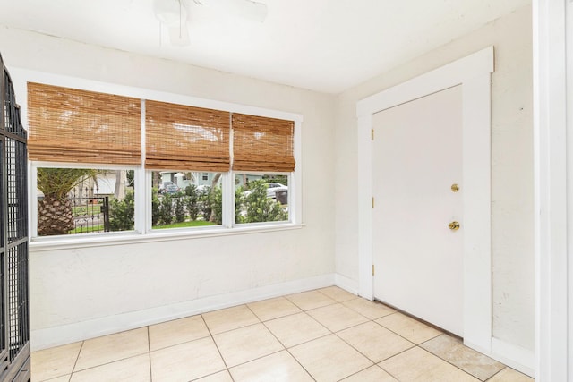 unfurnished room featuring baseboards and light tile patterned floors