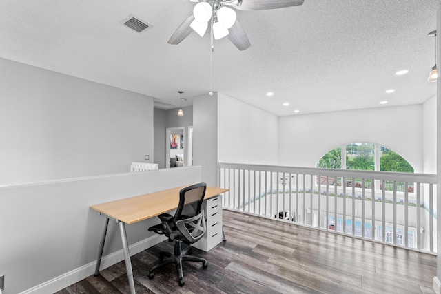 office space featuring recessed lighting, visible vents, a textured ceiling, and wood finished floors