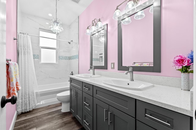 full bath with a sink, shower / tub combo with curtain, wood finished floors, and double vanity