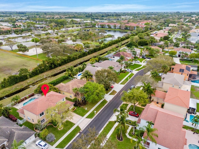 bird's eye view with a residential view and a water view