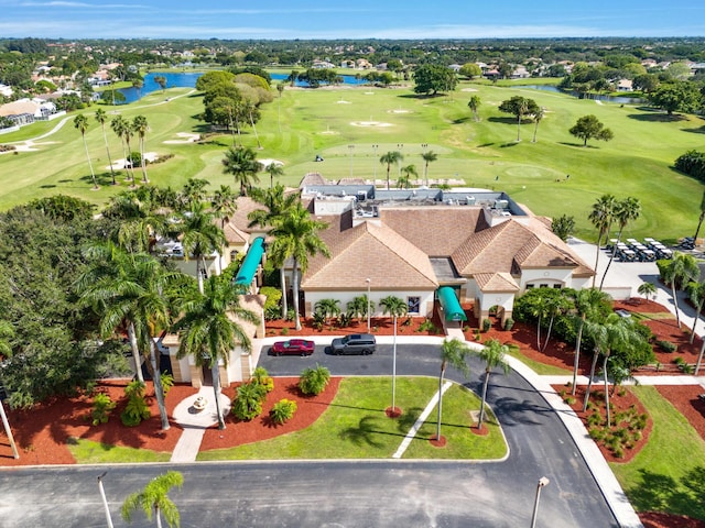 bird's eye view with a water view and view of golf course