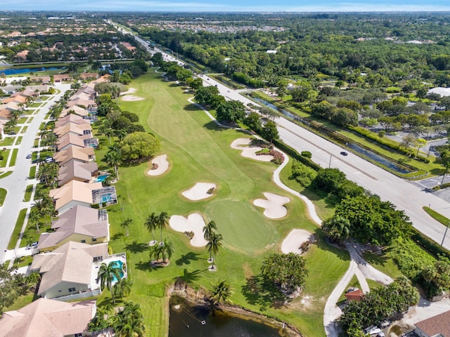 birds eye view of property with a residential view, a water view, and view of golf course