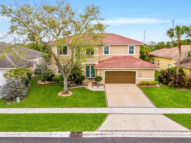 view of front facade featuring a garage, stucco siding, concrete driveway, and a front yard