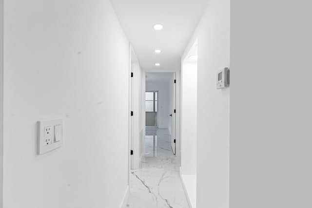 hallway featuring baseboards, marble finish floor, and recessed lighting