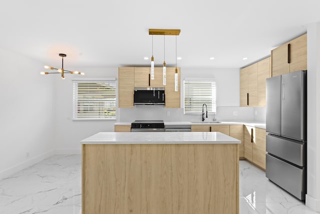 kitchen with marble finish floor, stainless steel appliances, light brown cabinets, a sink, and modern cabinets