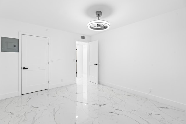 unfurnished bedroom featuring visible vents, electric panel, and baseboards