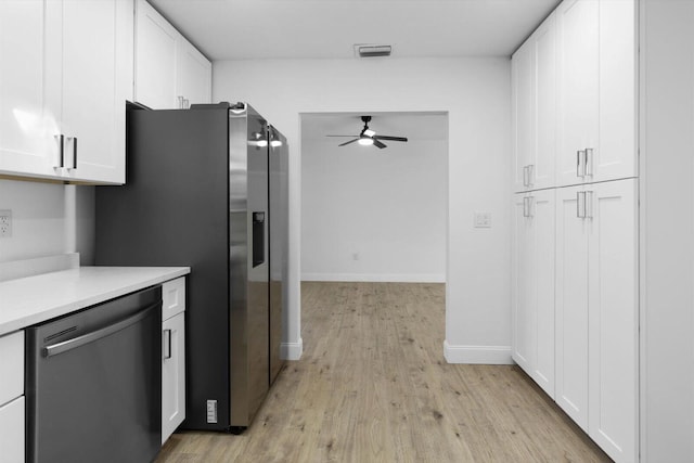 kitchen featuring dishwasher, light countertops, visible vents, and white cabinets