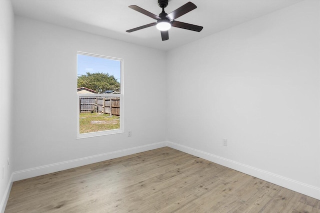 empty room with light wood-type flooring, ceiling fan, and baseboards