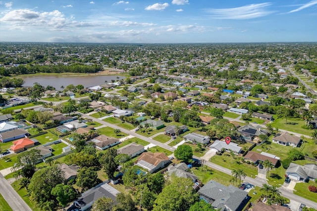 birds eye view of property featuring a water view and a residential view