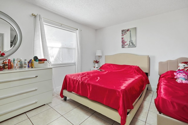 bedroom featuring light tile patterned floors and a textured ceiling