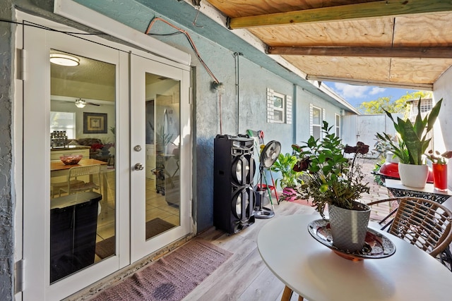 sunroom / solarium with french doors, beam ceiling, and wooden ceiling