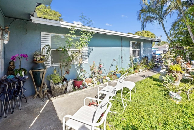 view of side of home with stucco siding