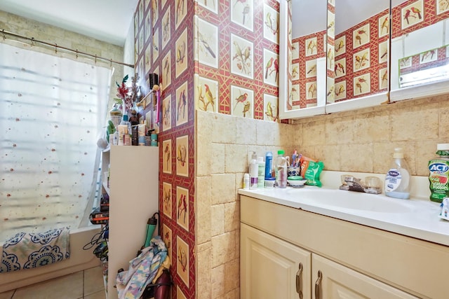 full bath with tile patterned flooring, decorative backsplash, vanity, and tile walls