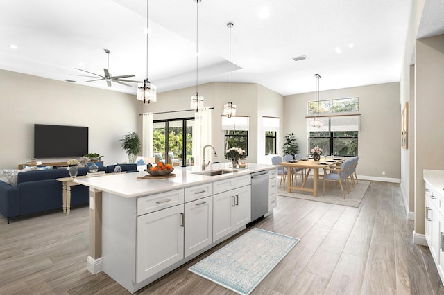 kitchen featuring visible vents, open floor plan, a sink, light countertops, and stainless steel dishwasher