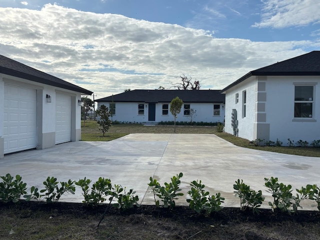 exterior space with a garage and stucco siding