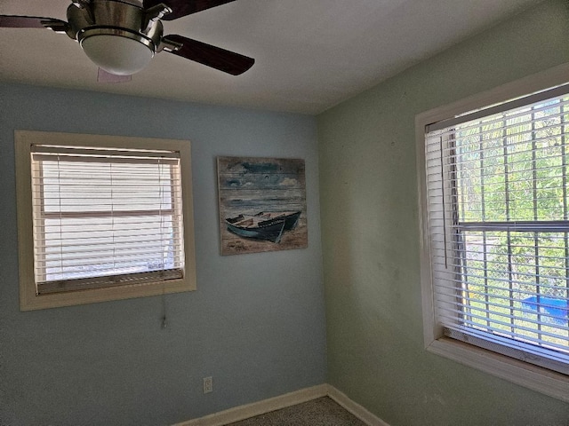 unfurnished room featuring ceiling fan and baseboards