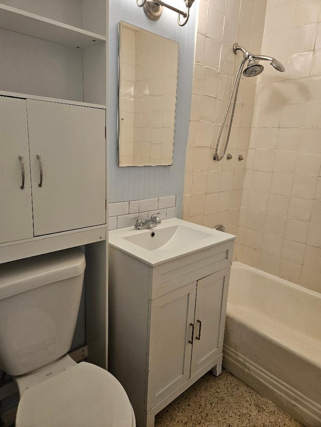 full bath featuring shower / bathtub combination, speckled floor, vanity, and toilet