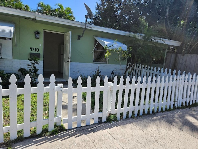 view of front of property with a fenced front yard and brick siding