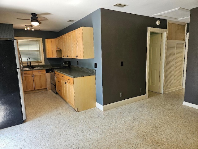 kitchen featuring dark countertops, visible vents, appliances with stainless steel finishes, and a sink