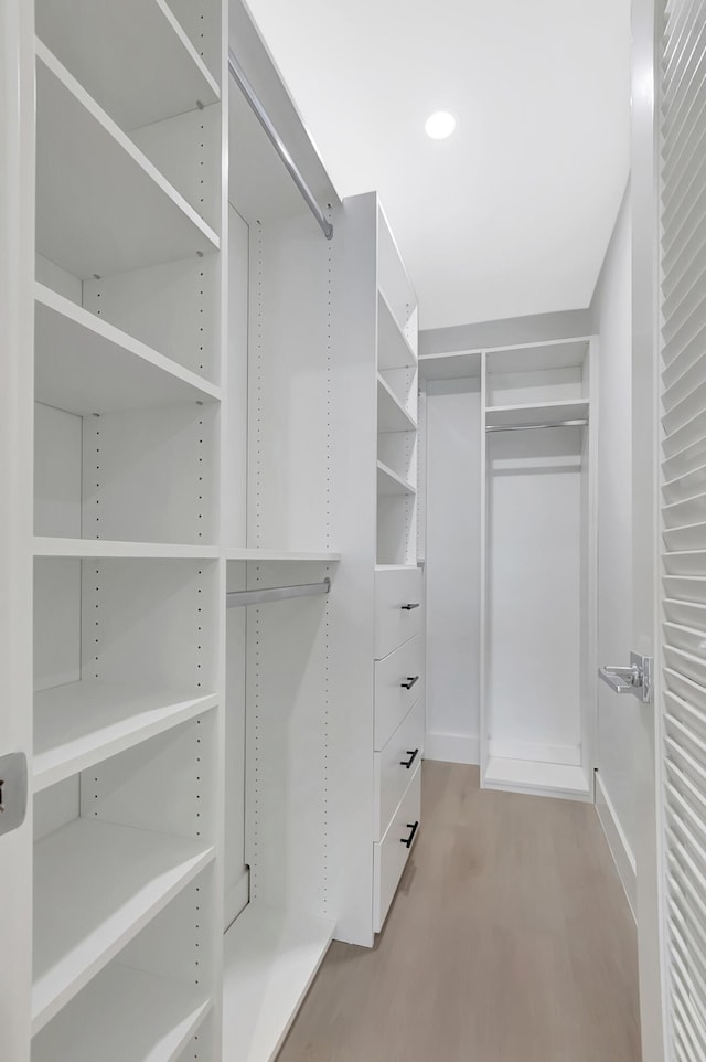 walk in closet featuring light wood-style flooring