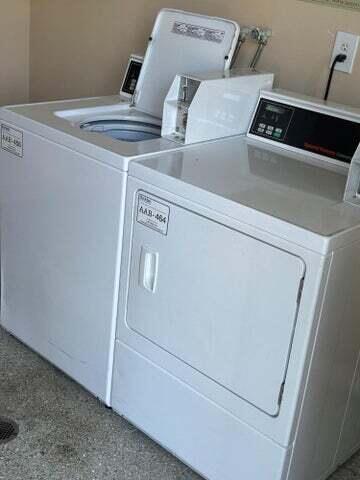 shared laundry area featuring washing machine and dryer