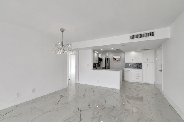 kitchen featuring stainless steel appliances, visible vents, white cabinets, marble finish floor, and tasteful backsplash