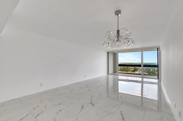 unfurnished room featuring a wall of windows, marble finish floor, a notable chandelier, and baseboards