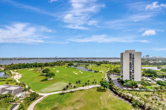 drone / aerial view with view of golf course, a water view, and a city view