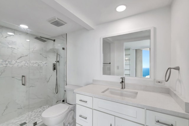 bathroom with a marble finish shower, visible vents, toilet, vanity, and recessed lighting