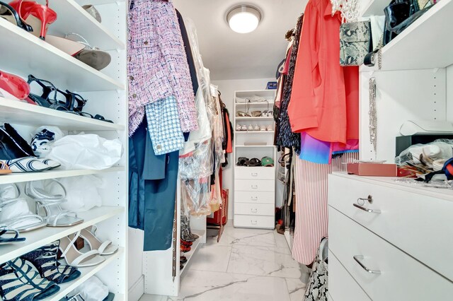 spacious closet with marble finish floor