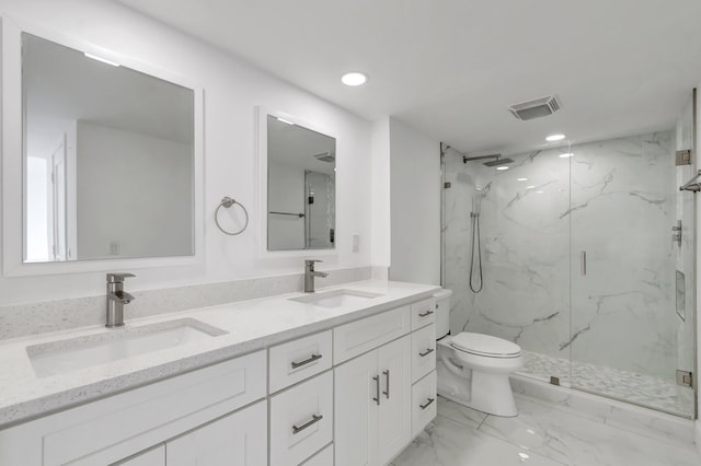 full bathroom featuring toilet, marble finish floor, a marble finish shower, and a sink