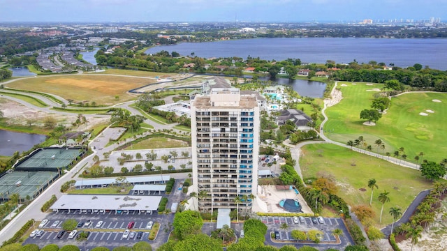 drone / aerial view featuring view of golf course and a water view