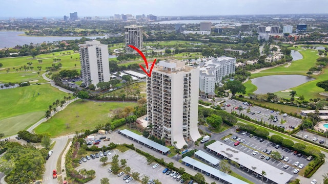 aerial view featuring a water view, a view of city, and golf course view