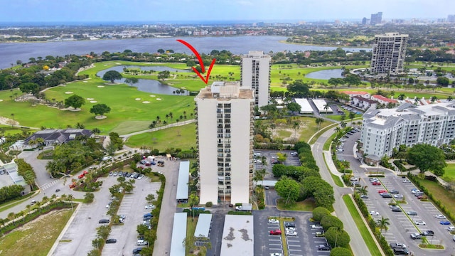 birds eye view of property featuring a water view, a view of city, and golf course view