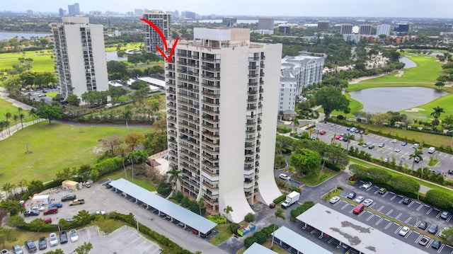 birds eye view of property with a water view, golf course view, and a city view