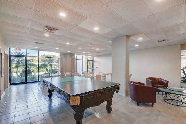 recreation room with a wall of windows, visible vents, and light tile patterned floors