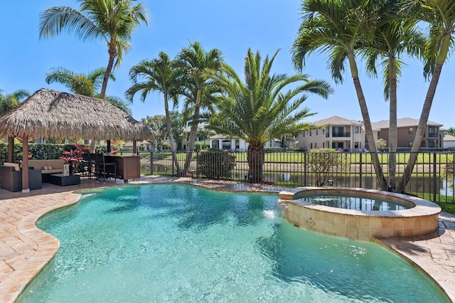 view of pool featuring a gazebo, a patio area, fence, and a pool with connected hot tub