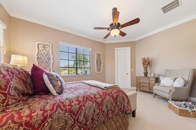 carpeted bedroom featuring visible vents, baseboards, a ceiling fan, and crown molding