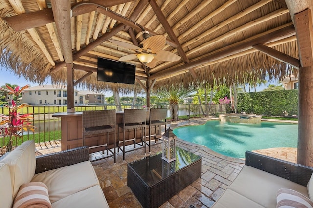 view of swimming pool with outdoor dry bar, a patio area, ceiling fan, and fence