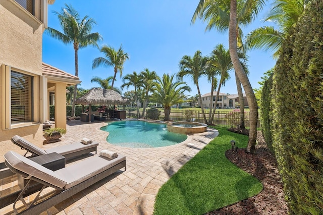 view of pool with an outdoor living space, a pool with connected hot tub, fence, a gazebo, and a patio