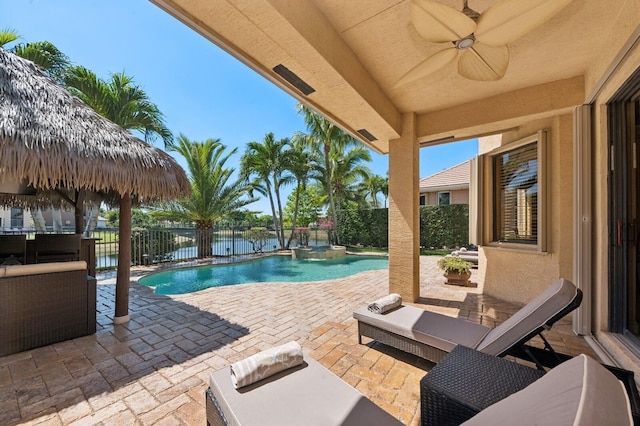 view of swimming pool with a patio, a fenced backyard, a ceiling fan, and a pool with connected hot tub