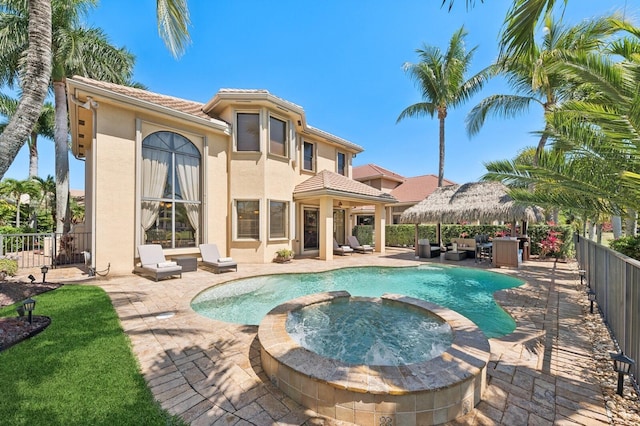 view of pool featuring a gazebo, a patio, fence, and a pool with connected hot tub